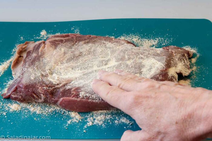 covering steak with flour + mustard