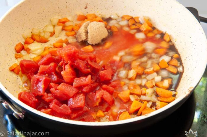 adding brown sugar, tomatoes, and worcestershire sauce to veggies in skillet