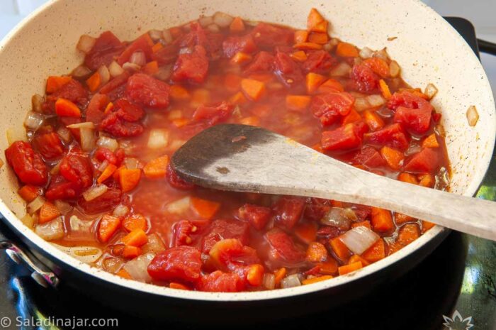 Cooking the sauce ingredients on the stove before pouring into the crockpot.