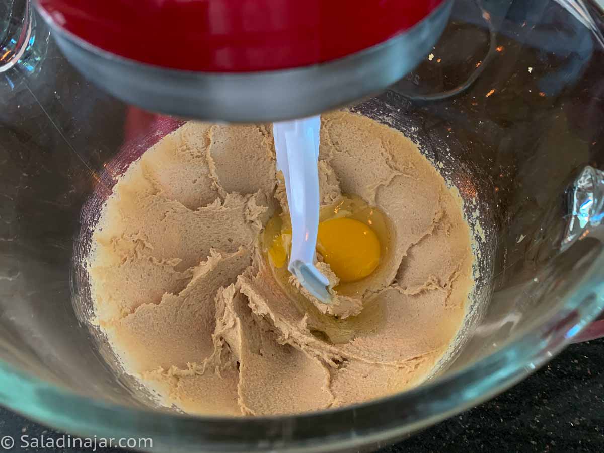 adding egg, vanilla extract, and almond extract