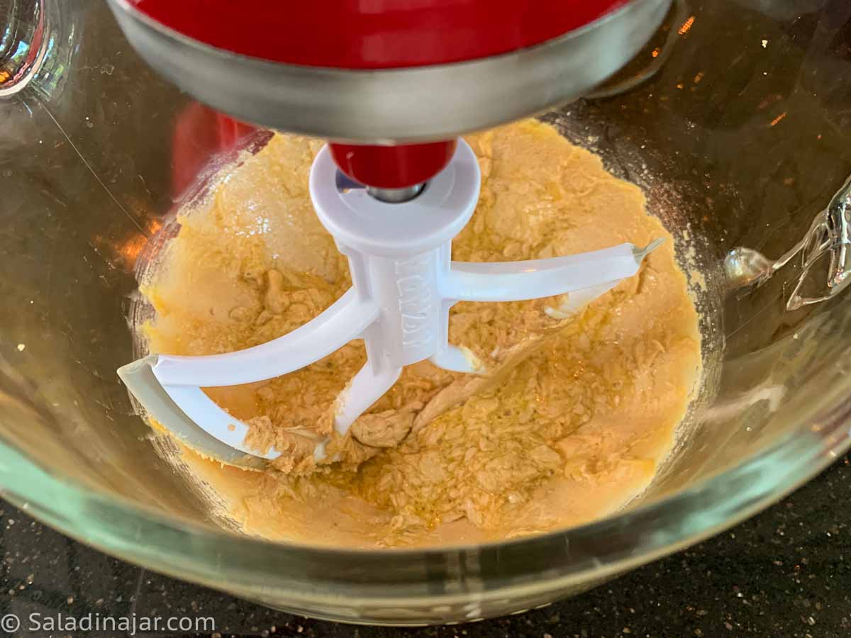 mixing sugar and butter with egg and extracts