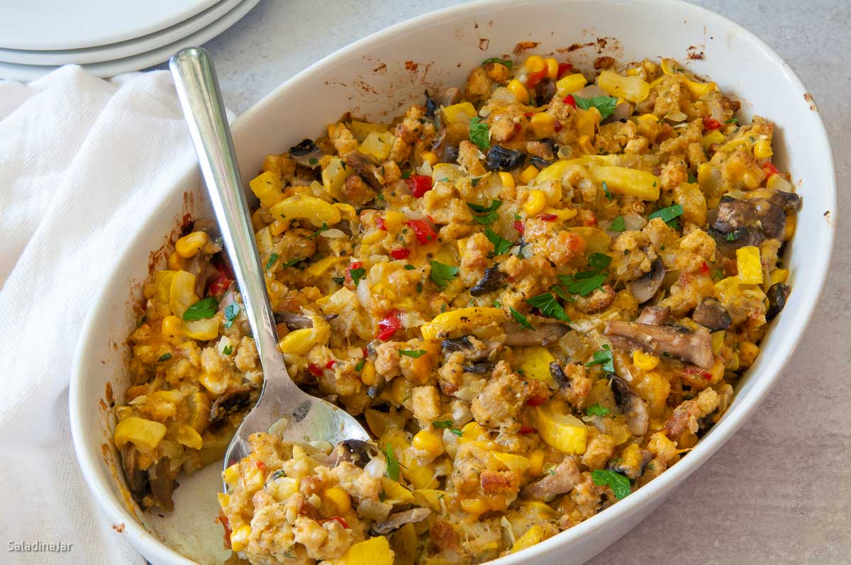 Yellow Squash Casserole in a serving dish with a serving spoon