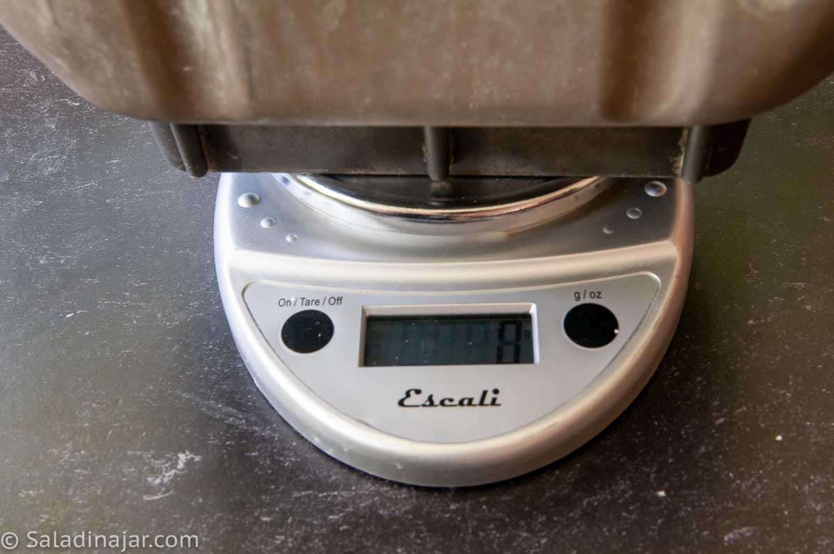 digital scales with bread machine sitting on top and display "zeroed out"