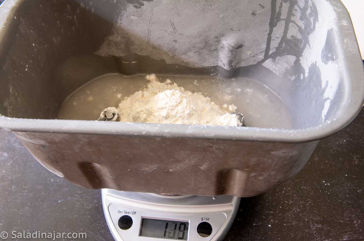 measuring flour with the bread machine pan sitting on top of the digital scales.