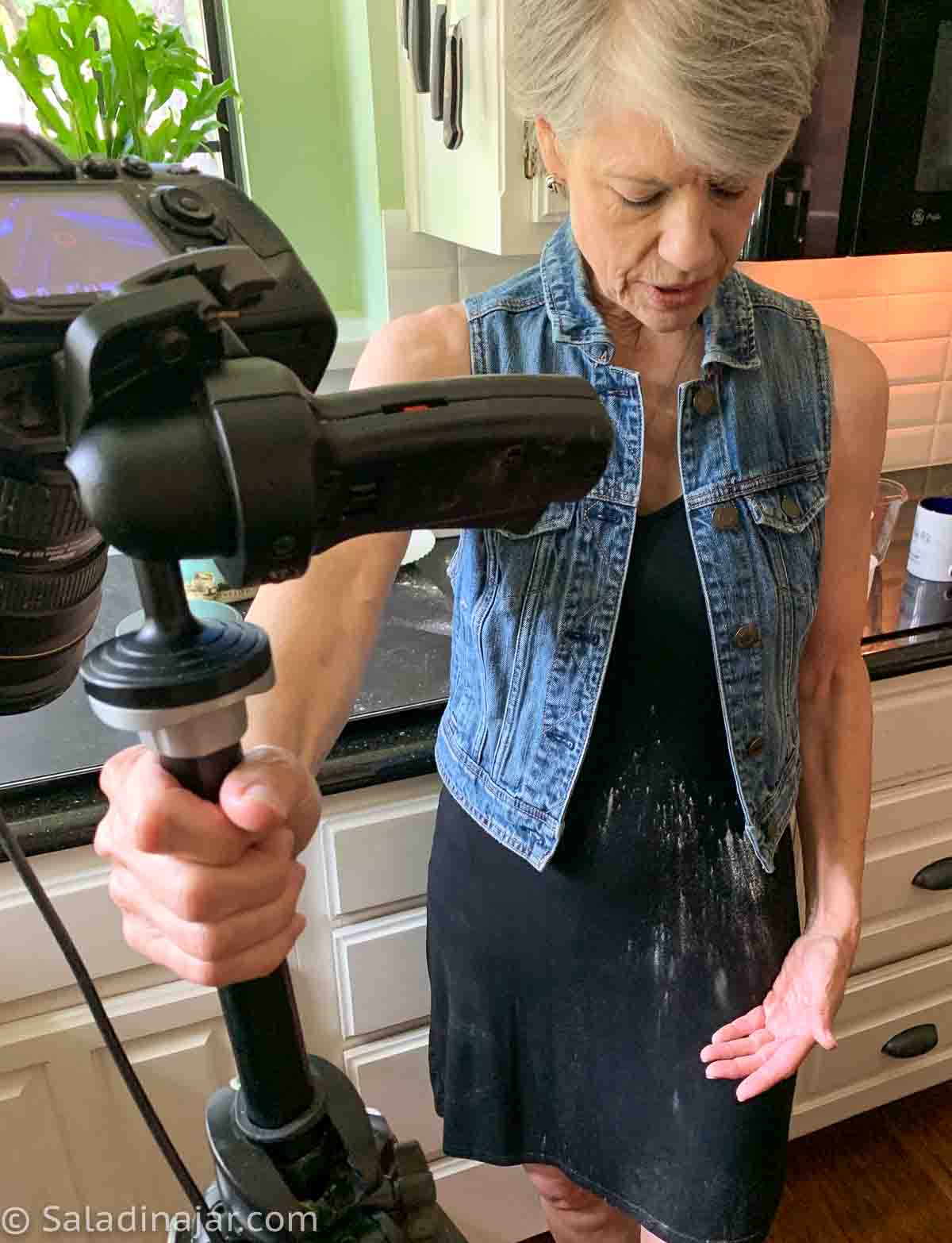 blog author wearing a black dress with flour on it