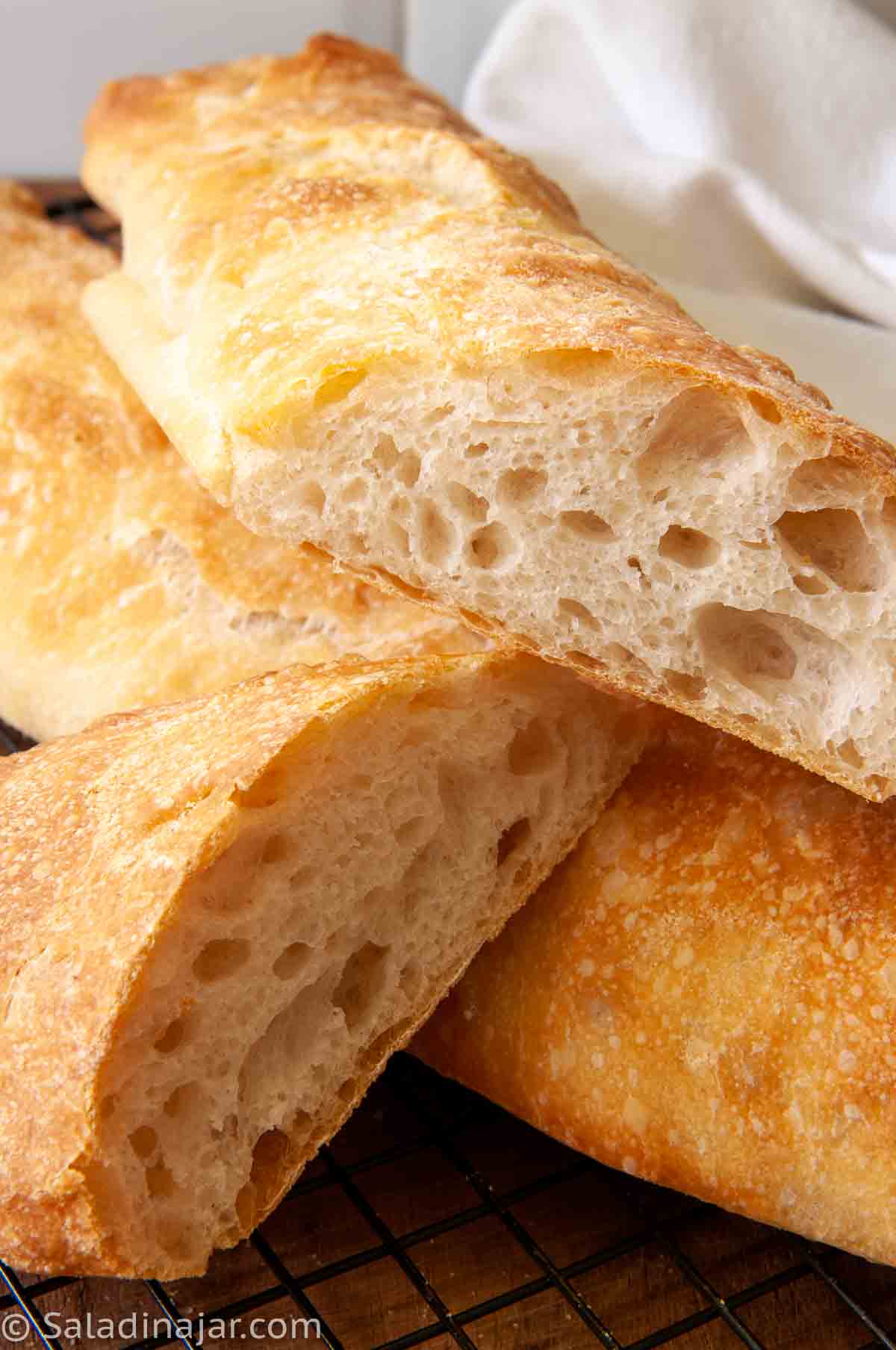 slices of ciabatta showing lots of holes and tunnels under a golden crust