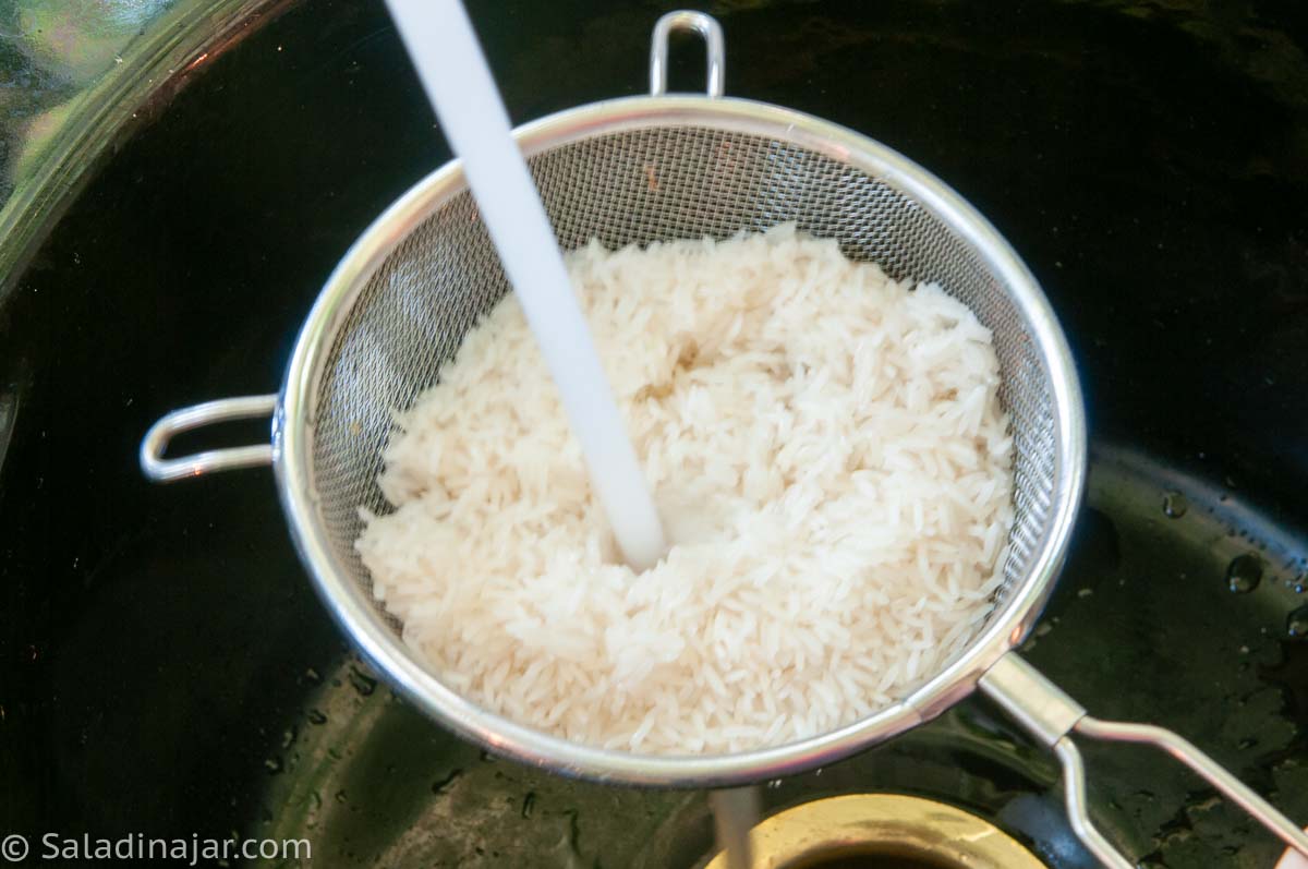 rinsing rice in a sieve.