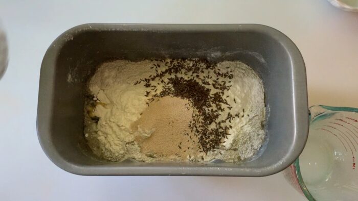 All ingredients added to the bread machine pan.