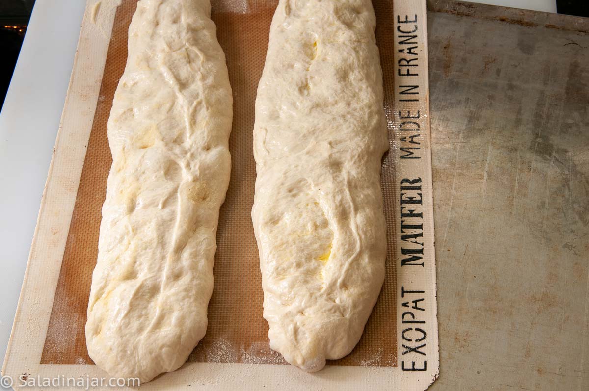 transferring loaves to a baking sheet.