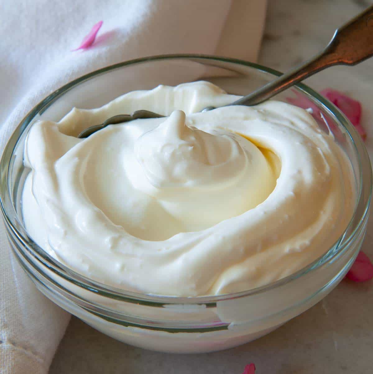 chilled creme fraiche in a serving bowl with a spoon