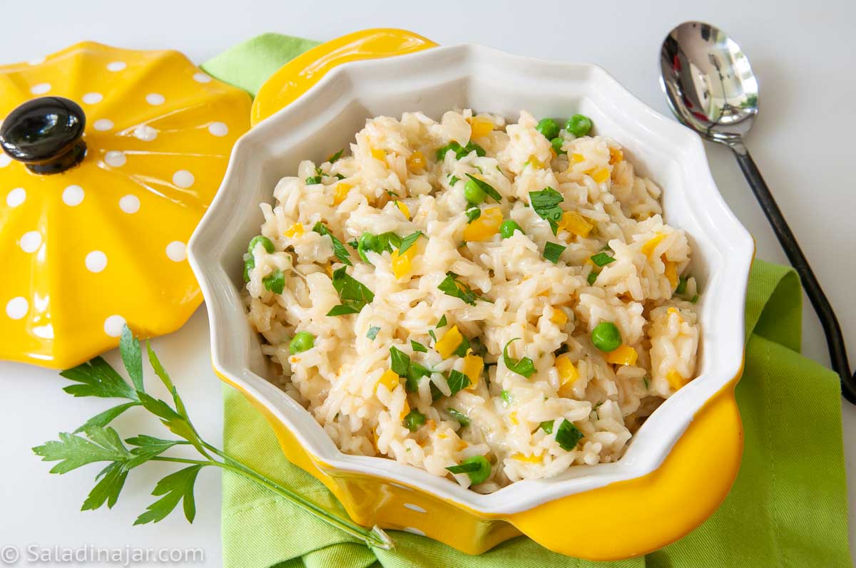 Cheesy Rice in serving bowl with spoon
