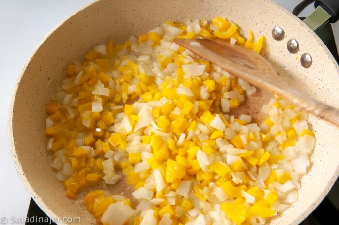 softening onions and yellow bell peppers.