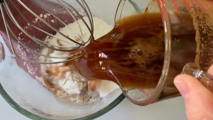 Adding instant espresso dissolved in water to the cake mix