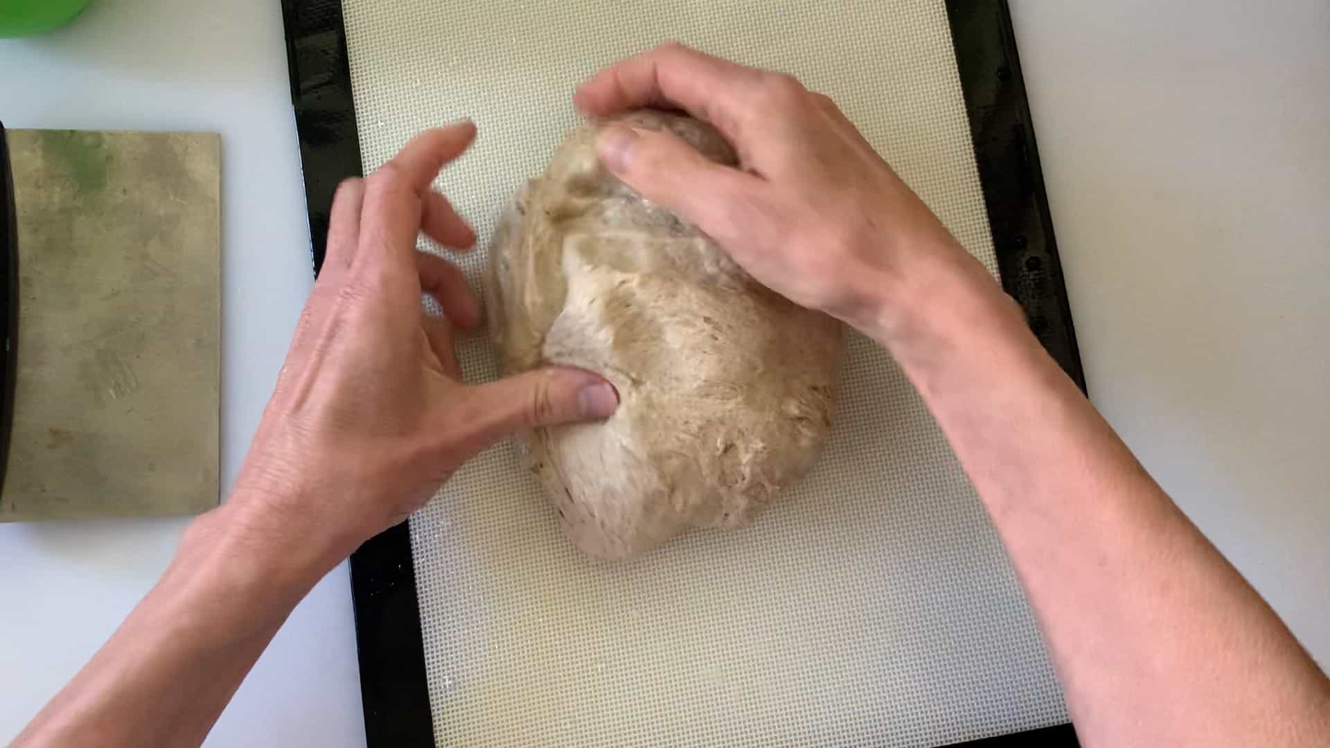 shaping dough into a ball.