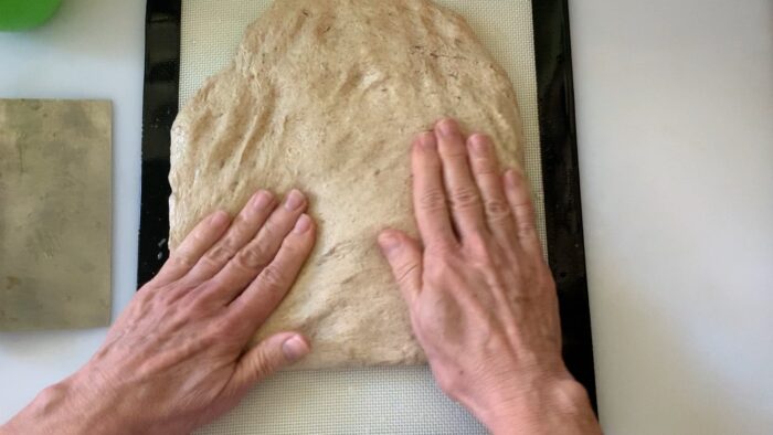 compressing the dough to make sure all bubbles are pressed down.