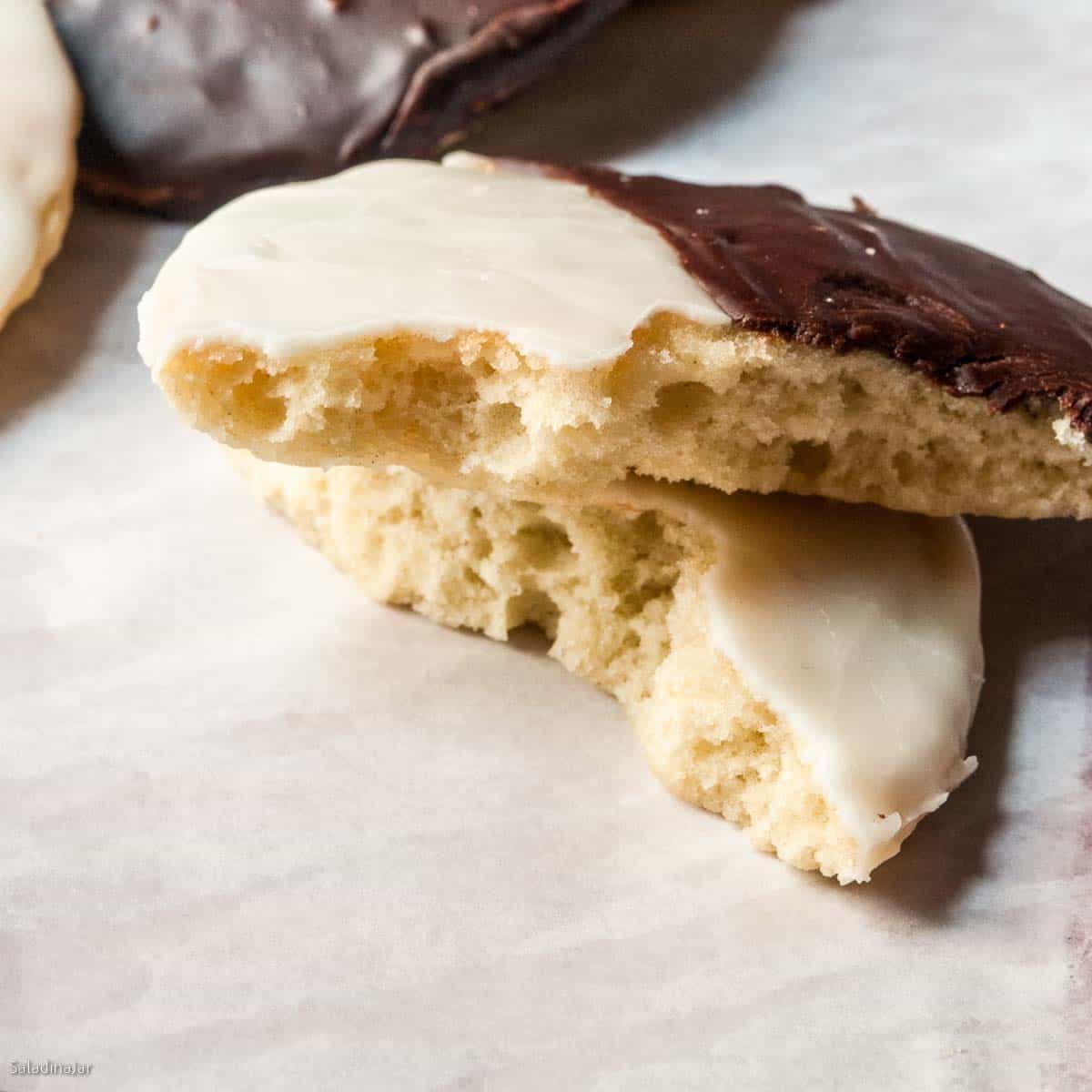 broken cookie showing the soft and cake-like texture inside.