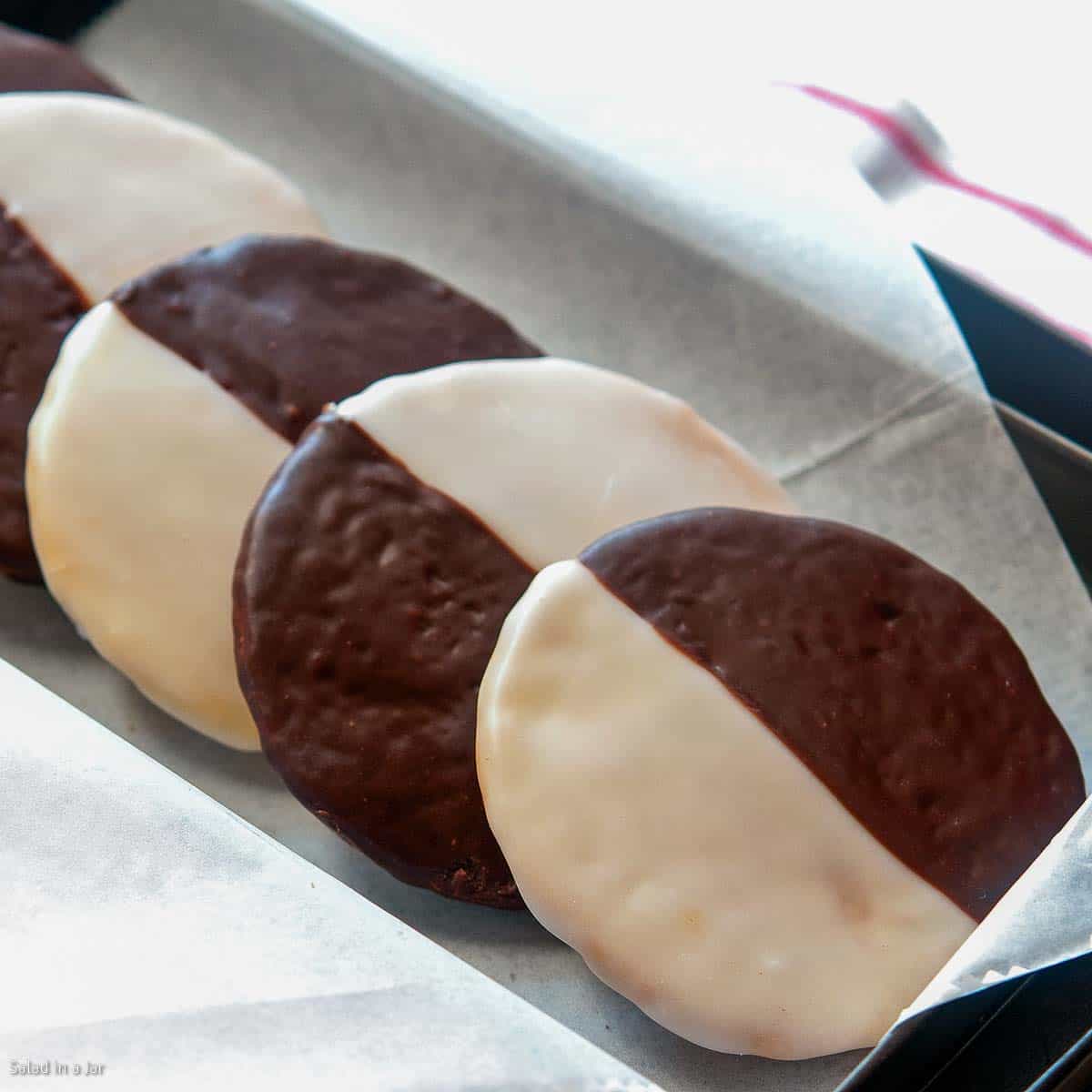 stack of mini black and white cookies in a tray