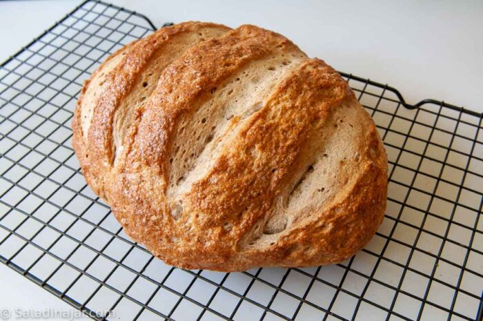 Fully baked loaf on cooling rack.
