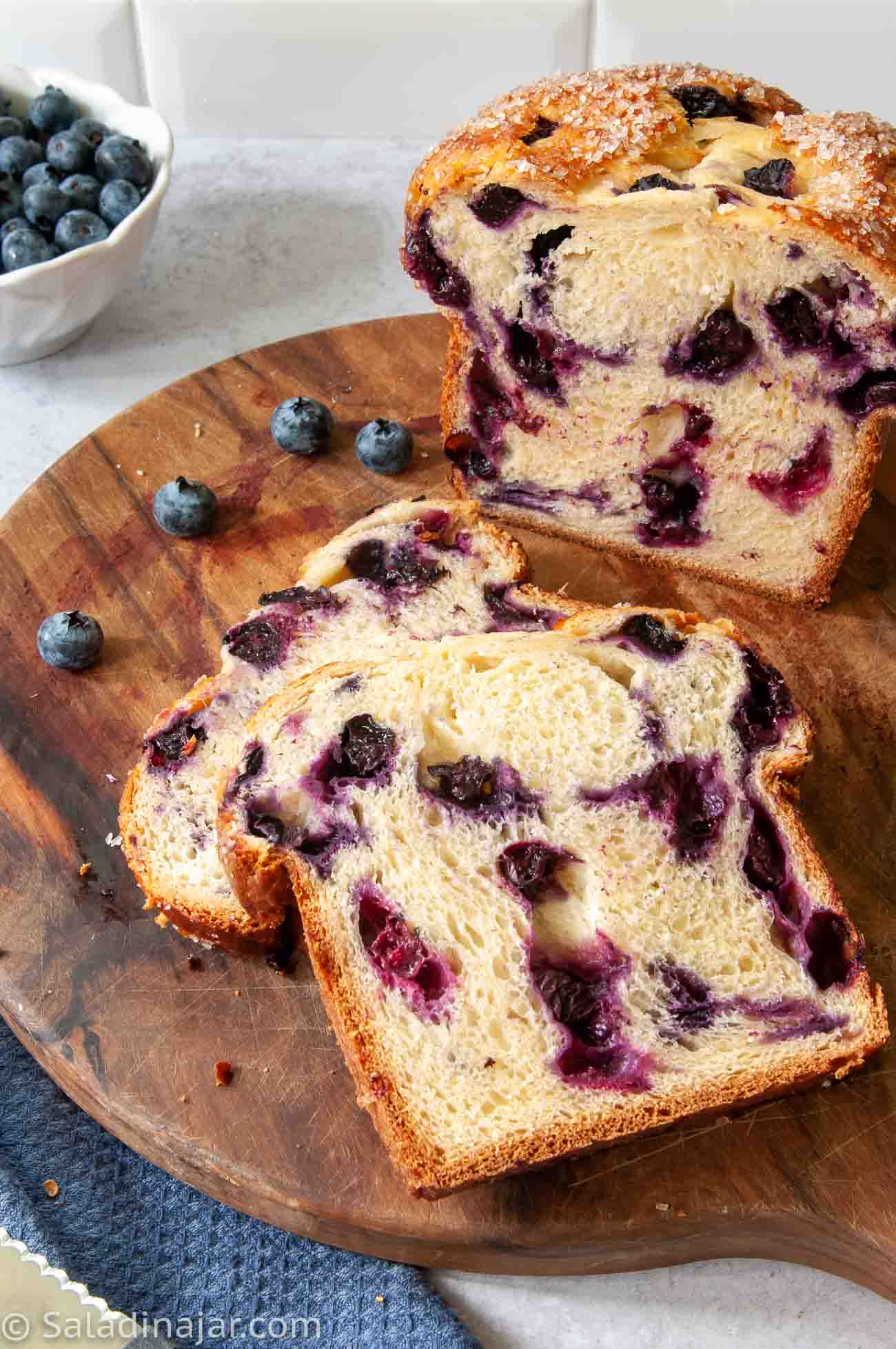 sliced sweet bread machine blueberry bread on a cutting board