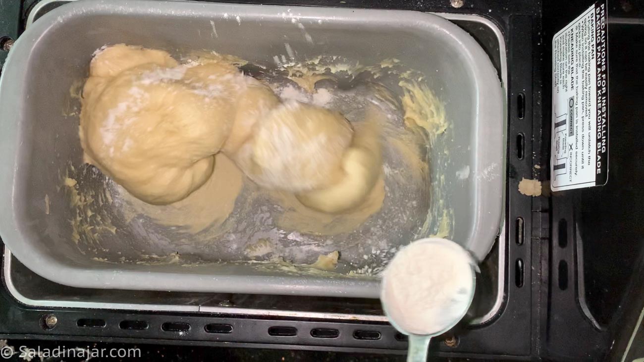 adding flour to wet dough