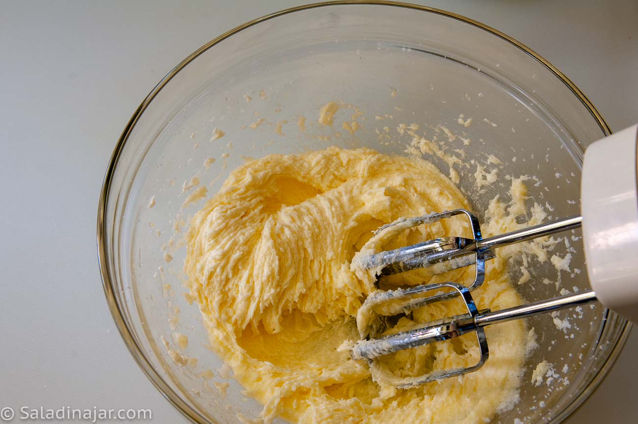 using a portable mixer to cream the butter and sugar.