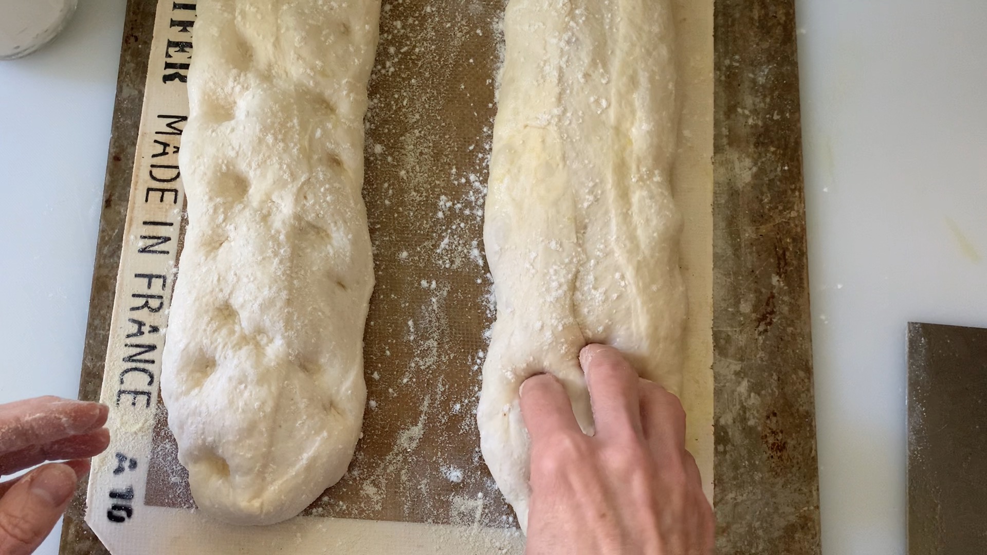 using fingers to dimple loaves