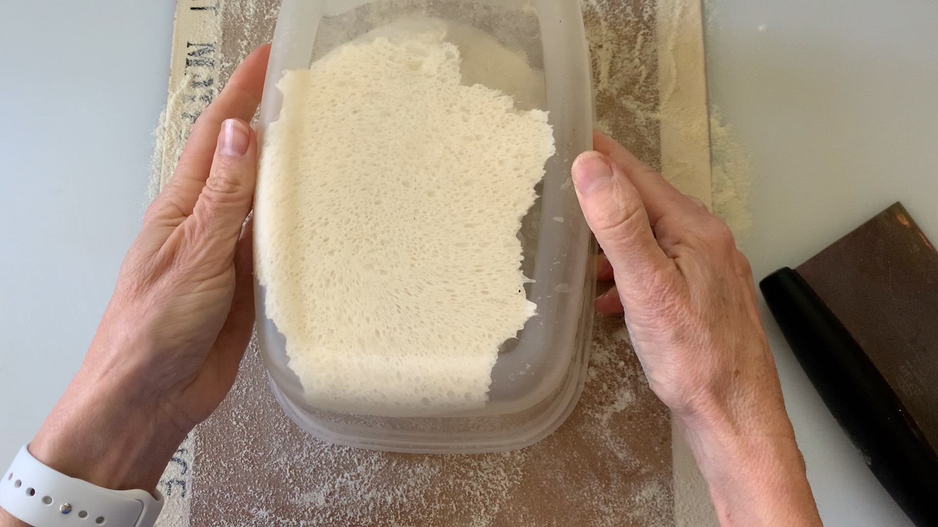 Turning bowl upside down to dump dough onto floured surface.