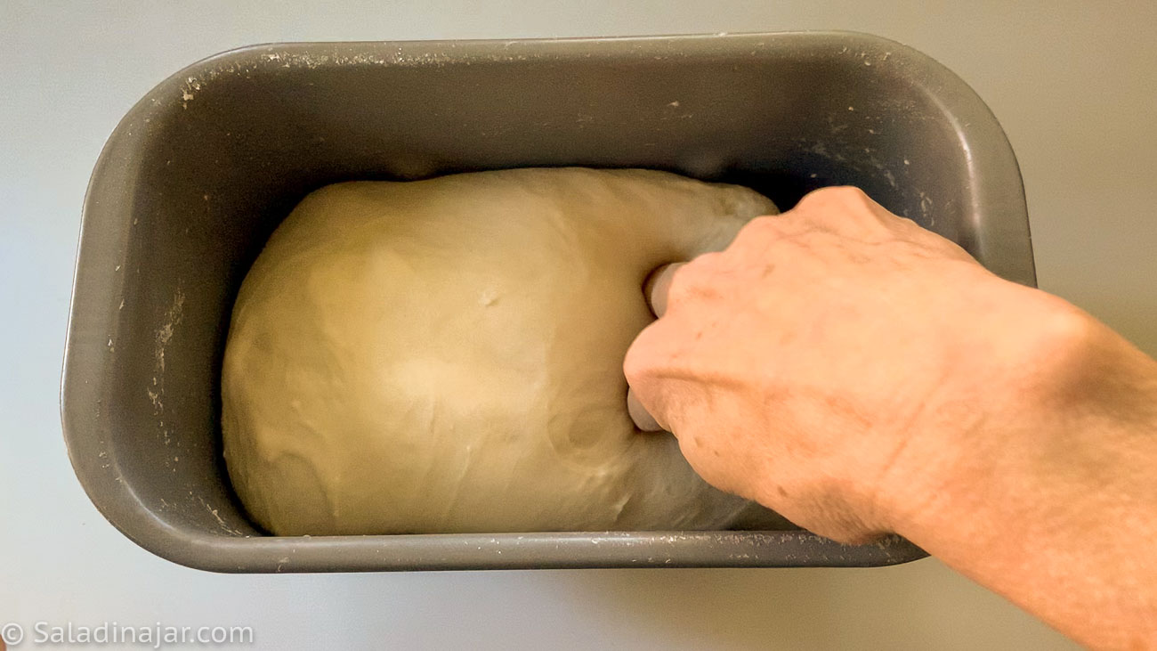 checking with fingers to see if dough has proofed enough