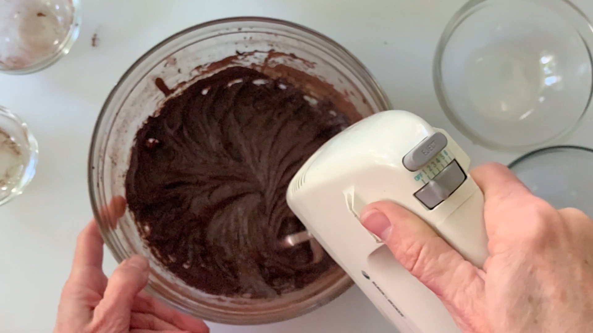 Mixing brownies on low speed with a hand mixer.