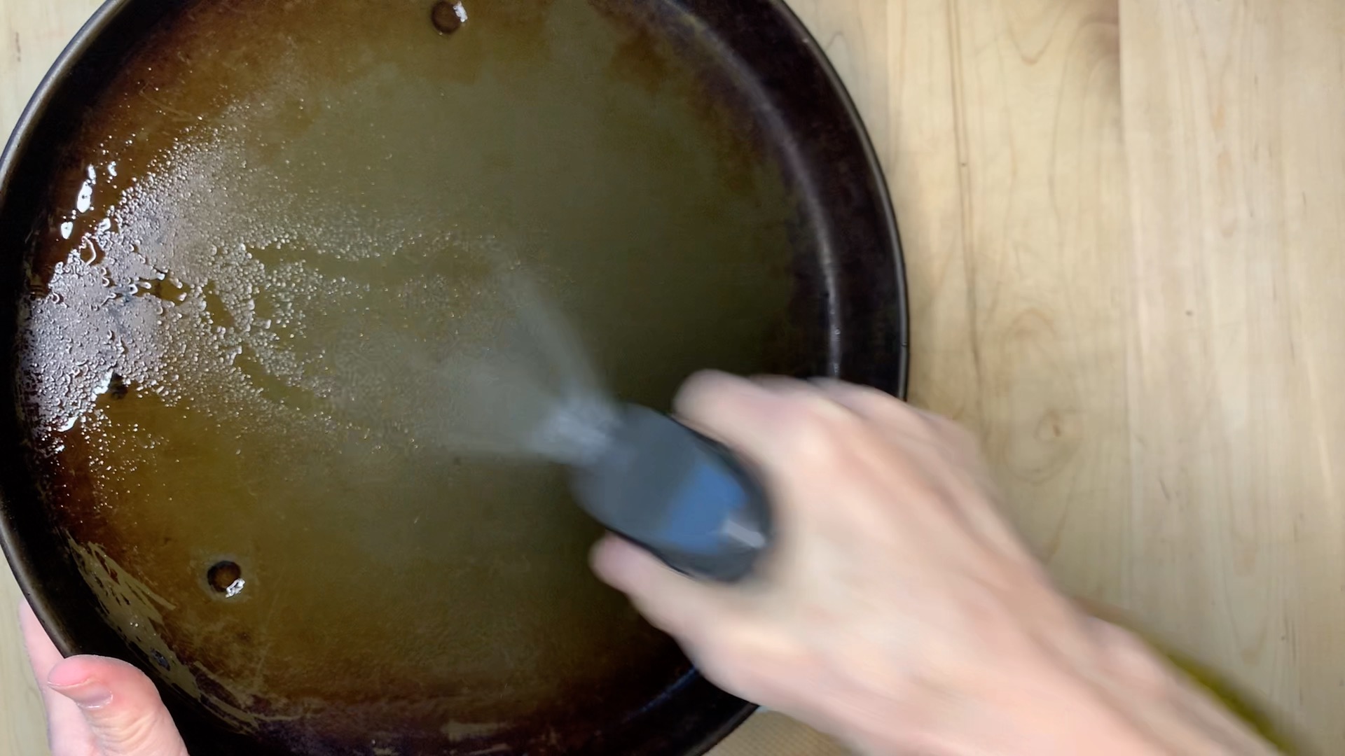 greasing the pan with oil spray