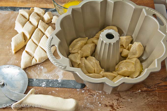 Adding pieces of dough to the pan