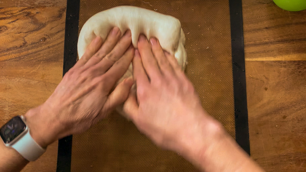 pressing large bubbles out of dough with fingers
