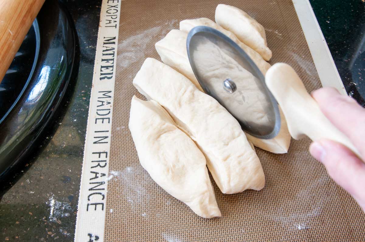 Use a pizza cutter to make diamond-shaped pieces of dough.