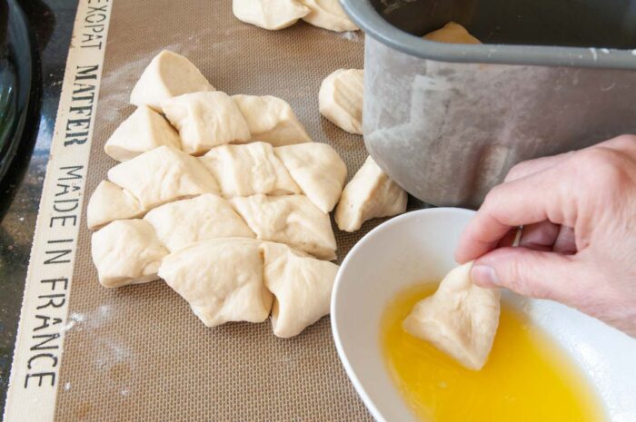 Dip each piece of dough into the butter.