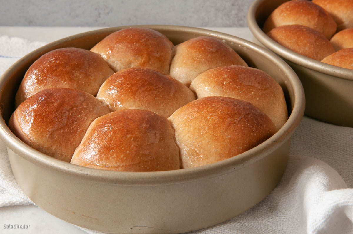baked whole wheat rolls still in the pan