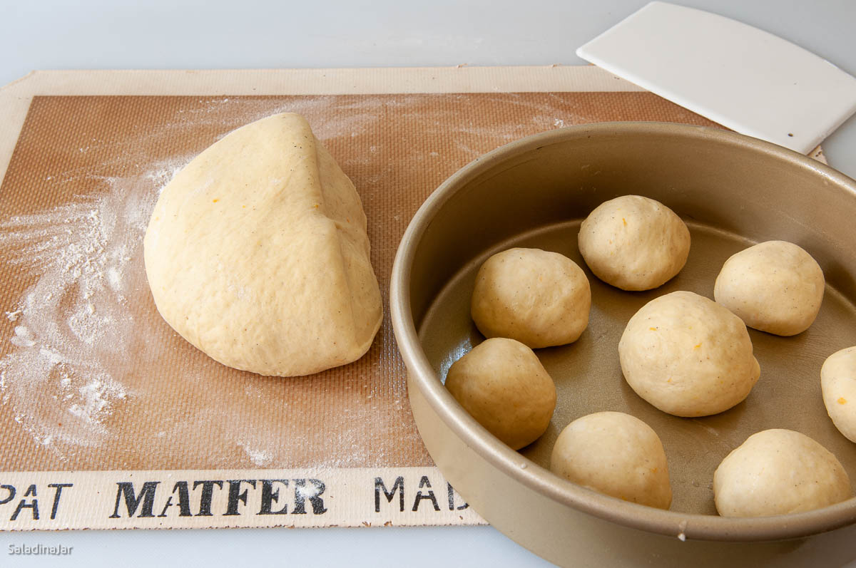 filling pans with unbaked rolls