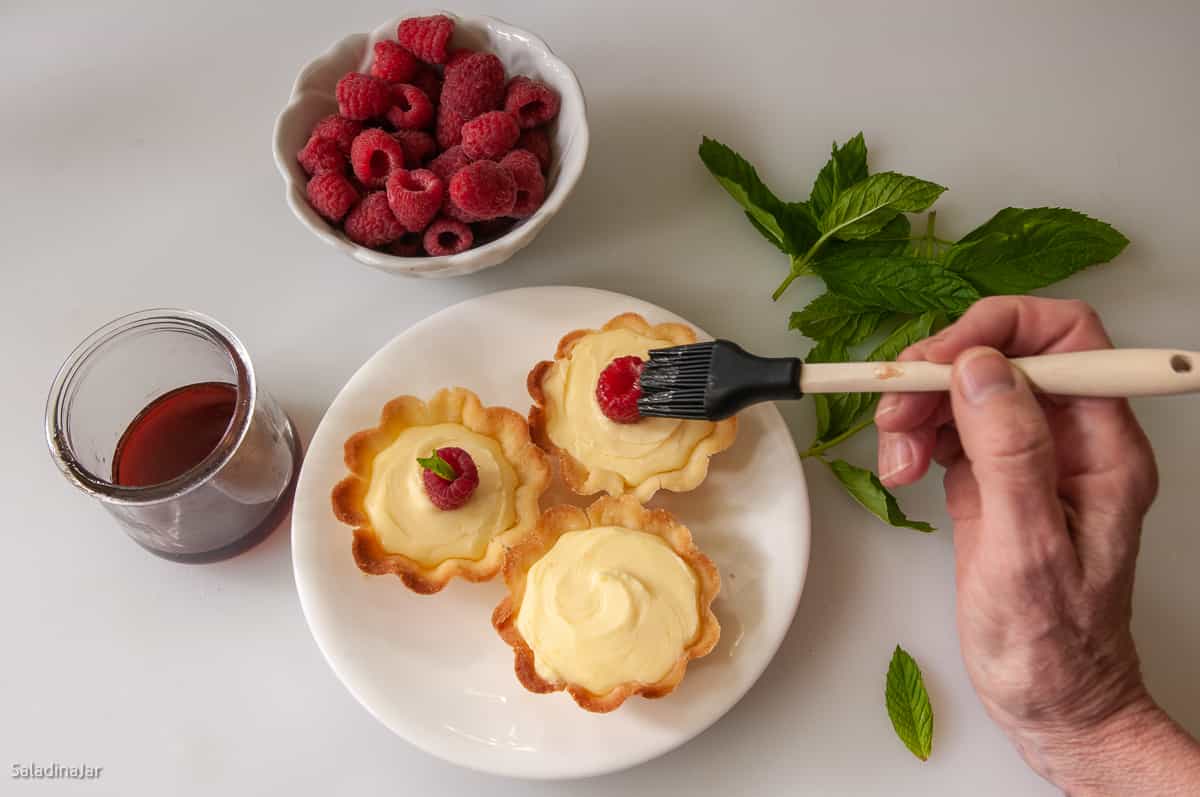 brushing tarts with glaze