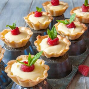 mini lemon tarts displayed on upside down muffin tin