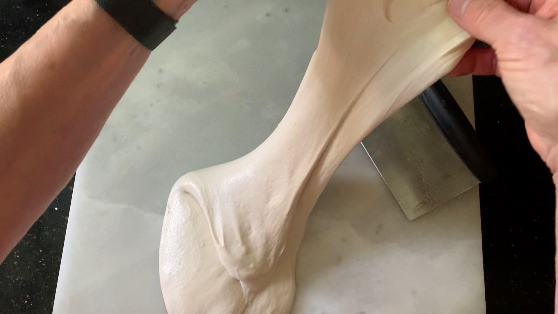 Stretching and folding the dough during pre-shape.