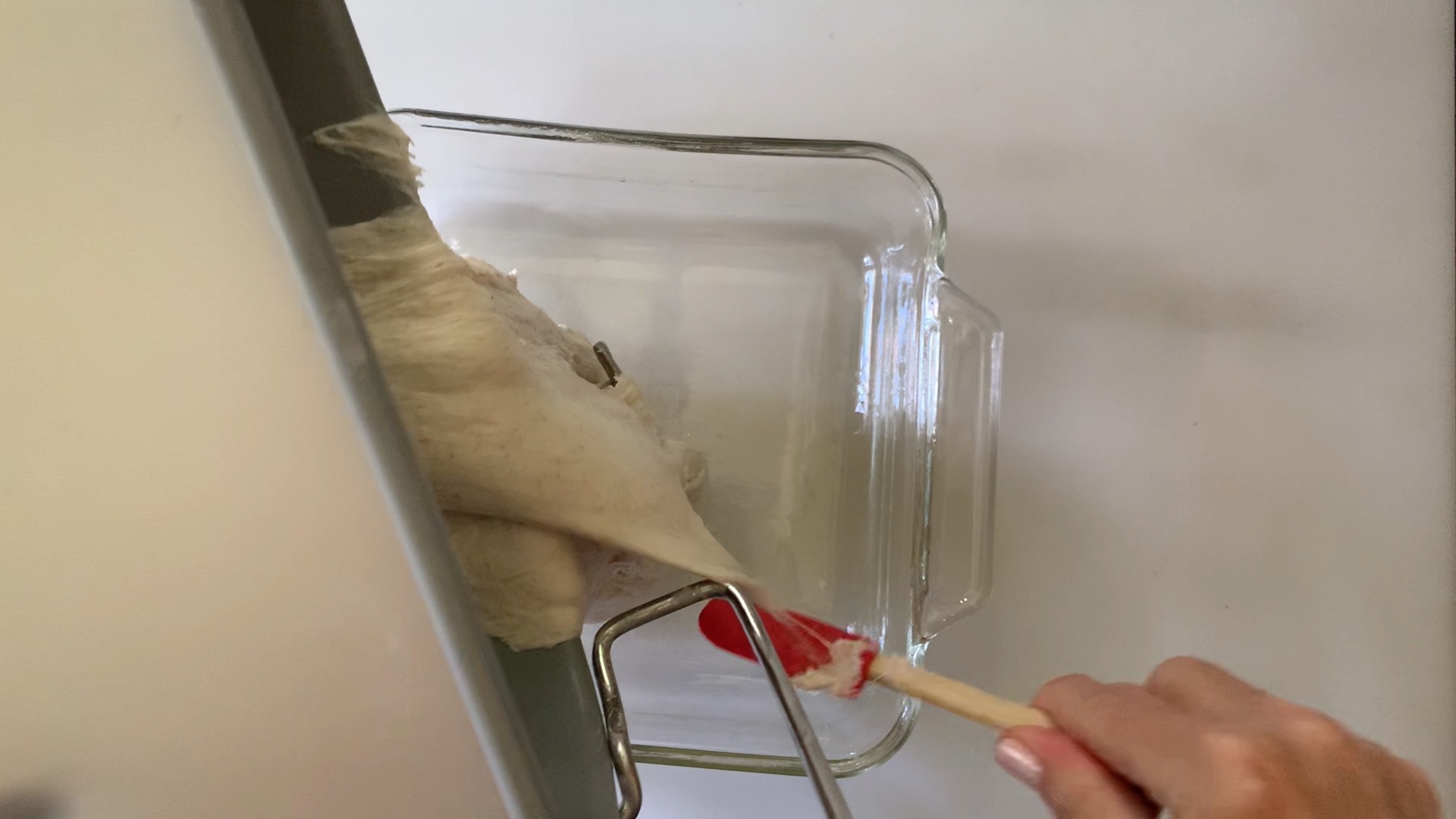 removing the dough from the bread machine to a clear container