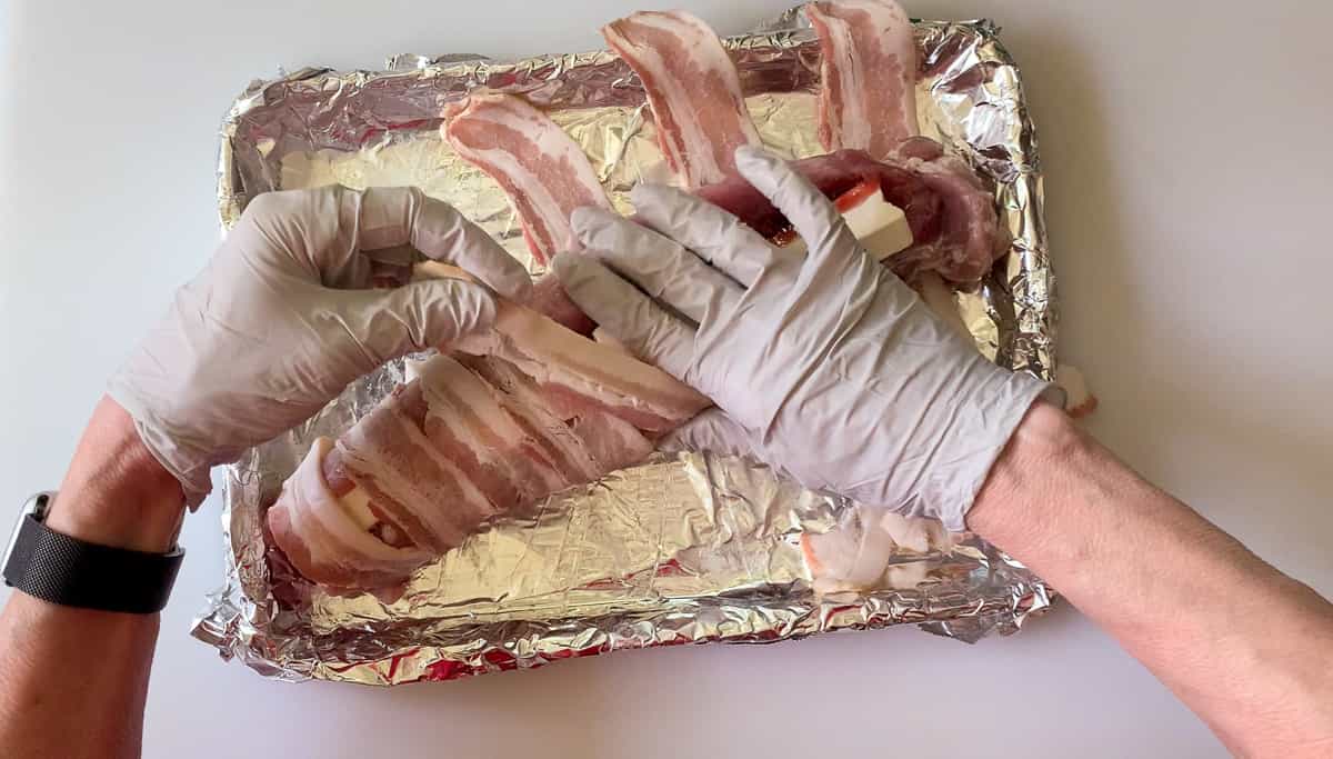 wrapping the bacon around the tenderloin stuffed with cheese