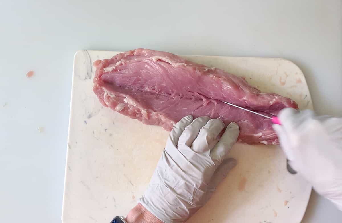 splitting tenderloin down the middle with a small but sharp knife.
