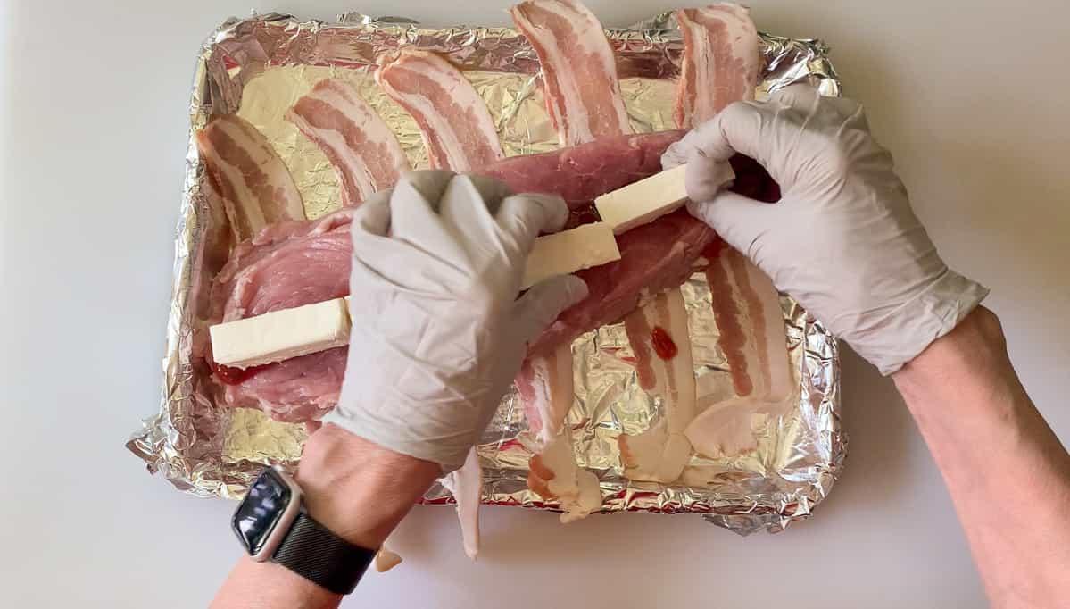 tucking cream cheese pieces inside the pork