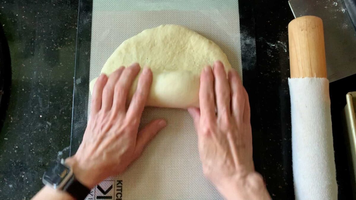 rolling the dough into a cylinder.