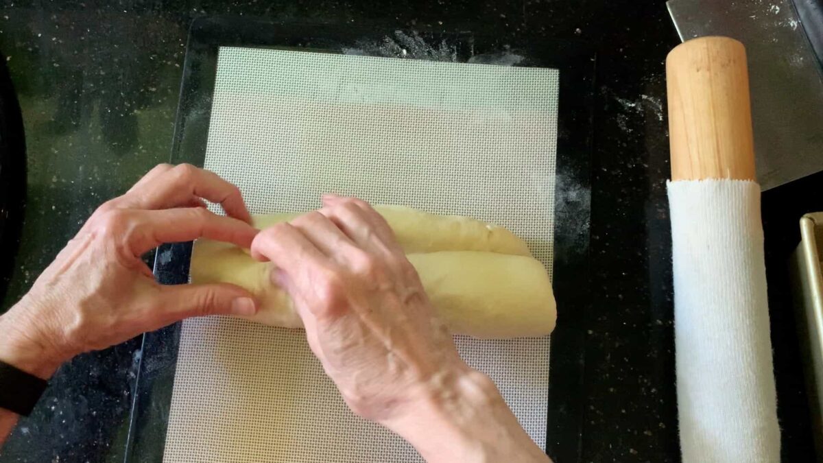 Pinching the seams together with fingers.