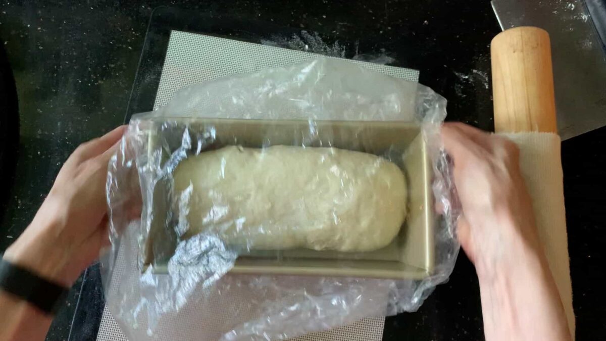 Covering the dough for the final rise.