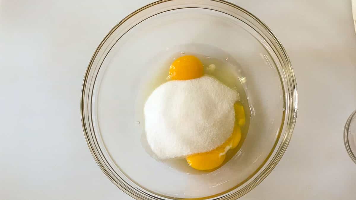Mixing eggs and sugar together in medium bowl