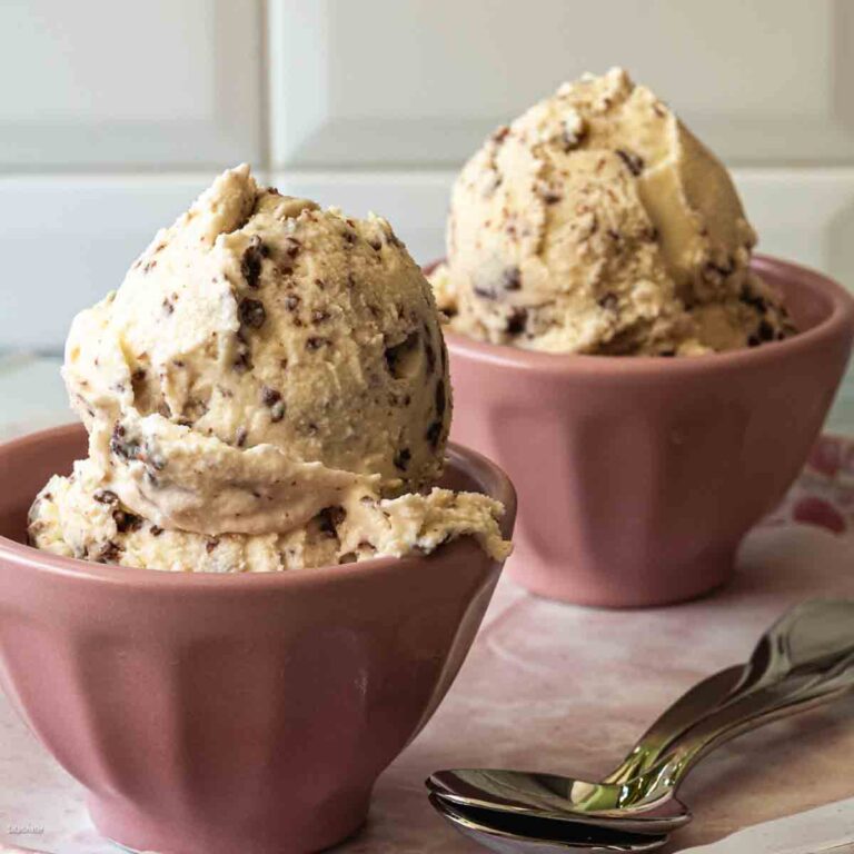scoops of creme fraiche ice cream with Nutella flakes in pink bowls.