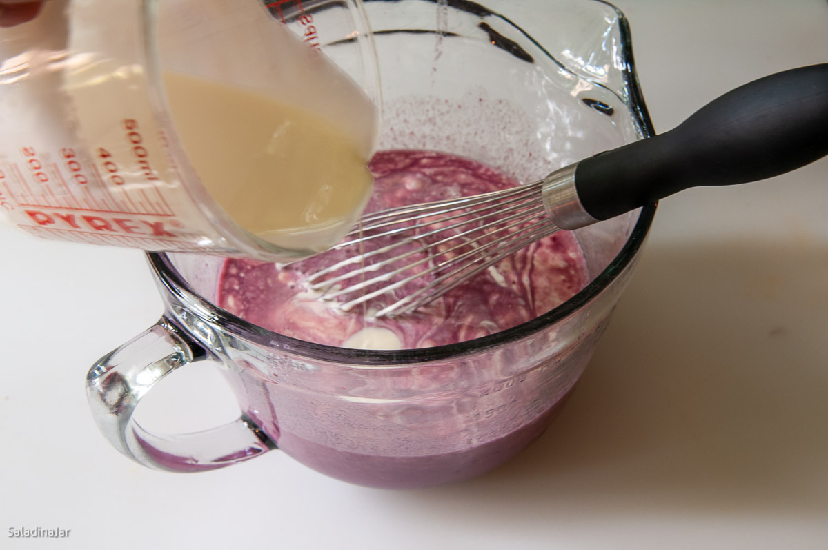 adding cream to berries