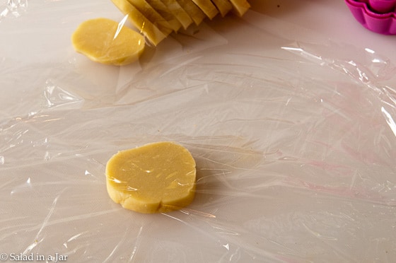 getting ready to press out the dough using clear wrap